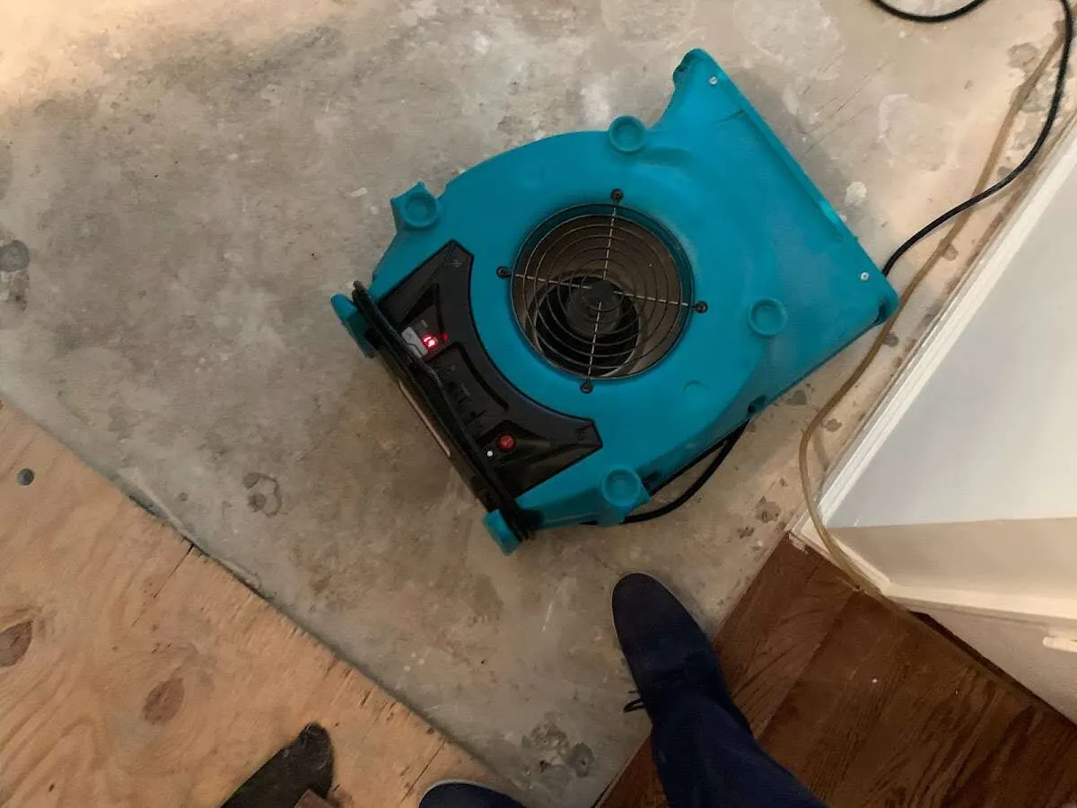 Air mover drying subfloor during Commercial Water Damage Restoration in Totowa